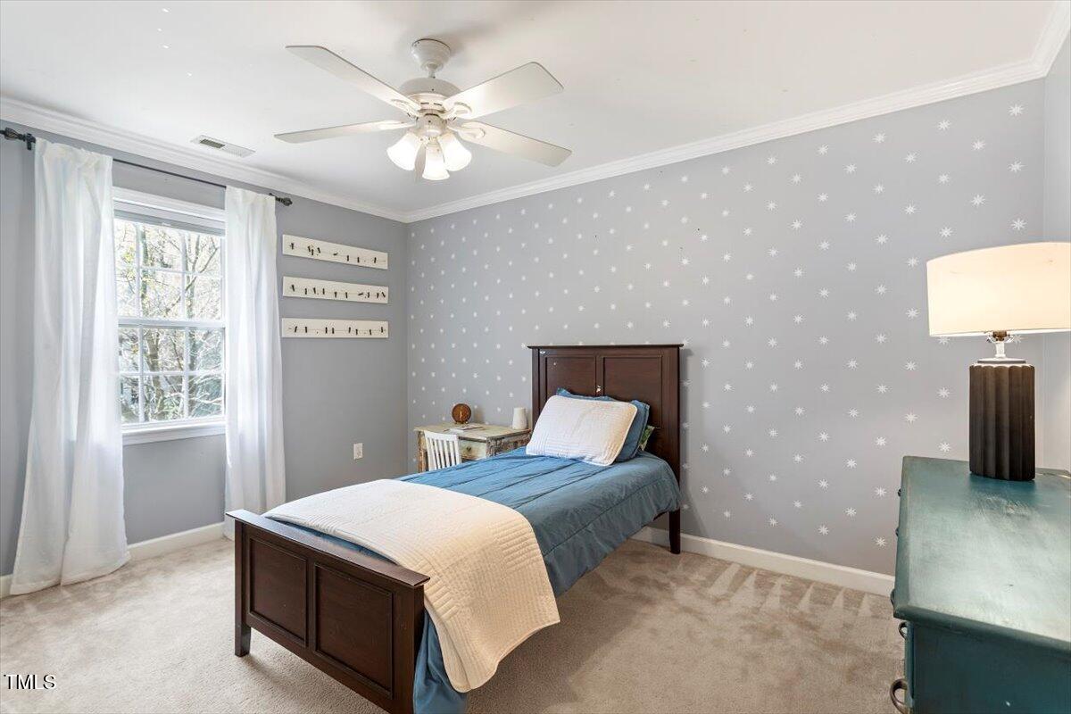 4725 Sinclair Drive Raleigh, NC 27616 - Photo 19 of 36 a spacious bedroom with a bed and a chandelier