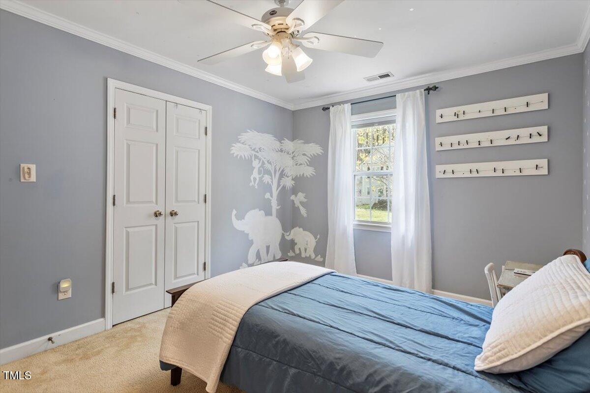 4725 Sinclair Drive Raleigh, NC 27616 - Photo 20 of 36 a bedroom with a bed and a window