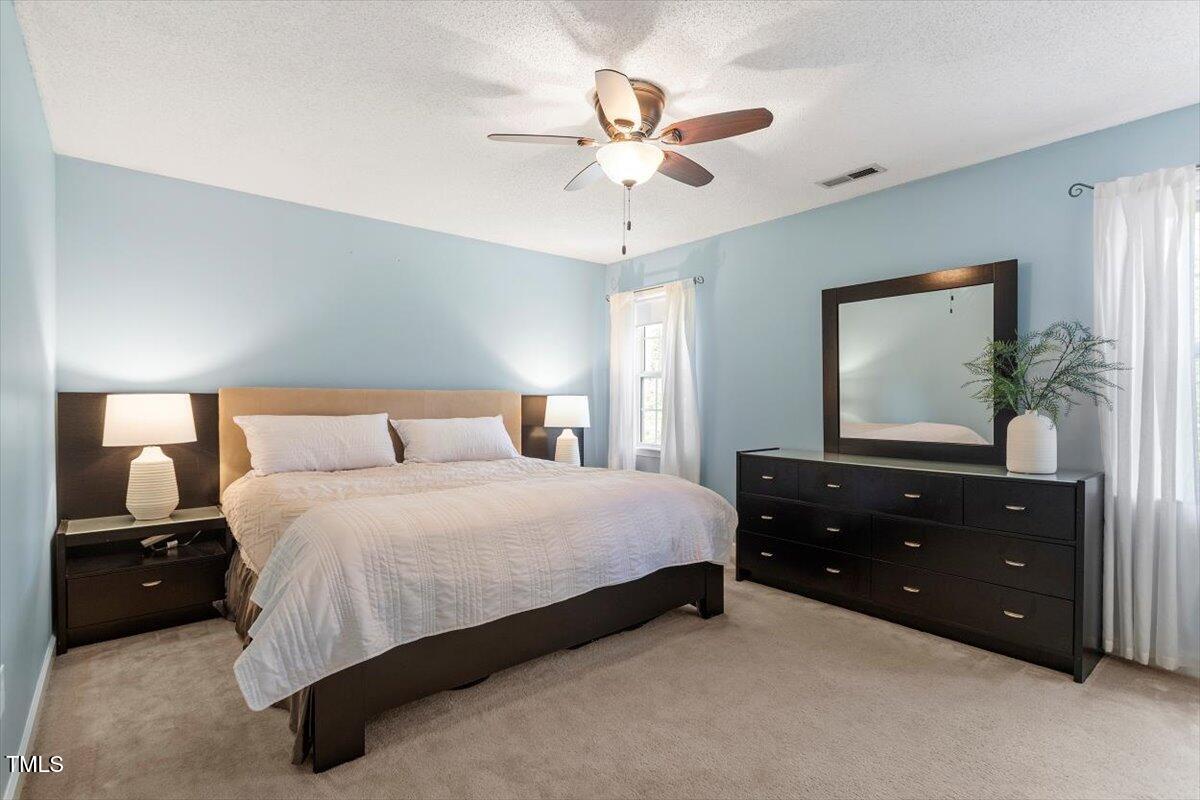 4725 Sinclair Drive Raleigh, NC 27616 - Photo 24 of 36 a bedroom with a bed and a chandelier