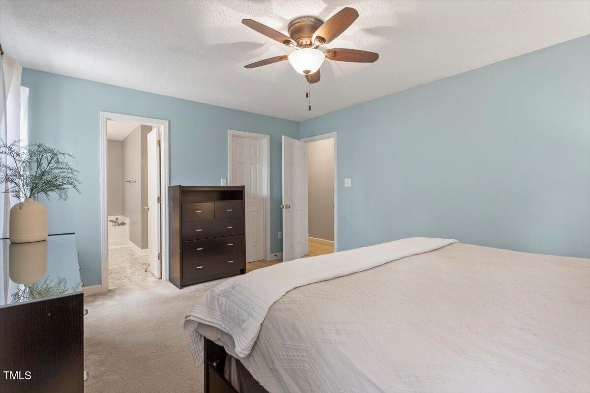 4725 Sinclair Drive Raleigh, NC 27616 - Photo 26 of 36 a bedroom with a bed and a chandelier