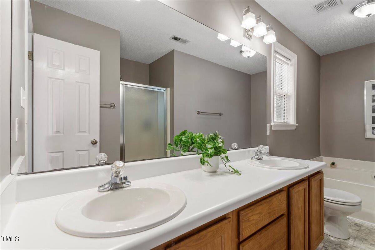 4725 Sinclair Drive Raleigh, NC 27616 - Photo 27 of 36 a bathroom with a sink double vanity and a mirror