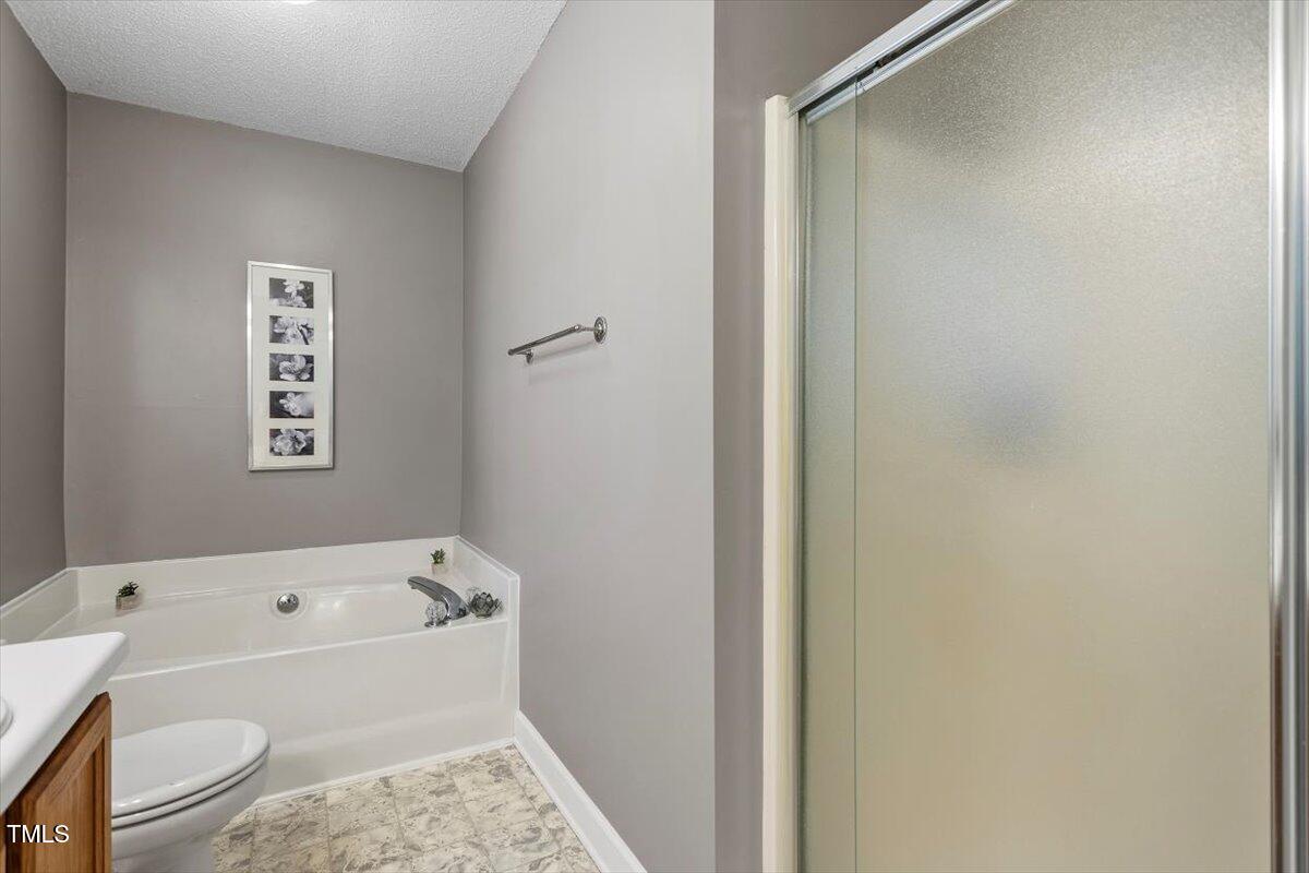 4725 Sinclair Drive Raleigh, NC 27616 - Photo 28 of 36 a bathroom with a bathtub and a toilet