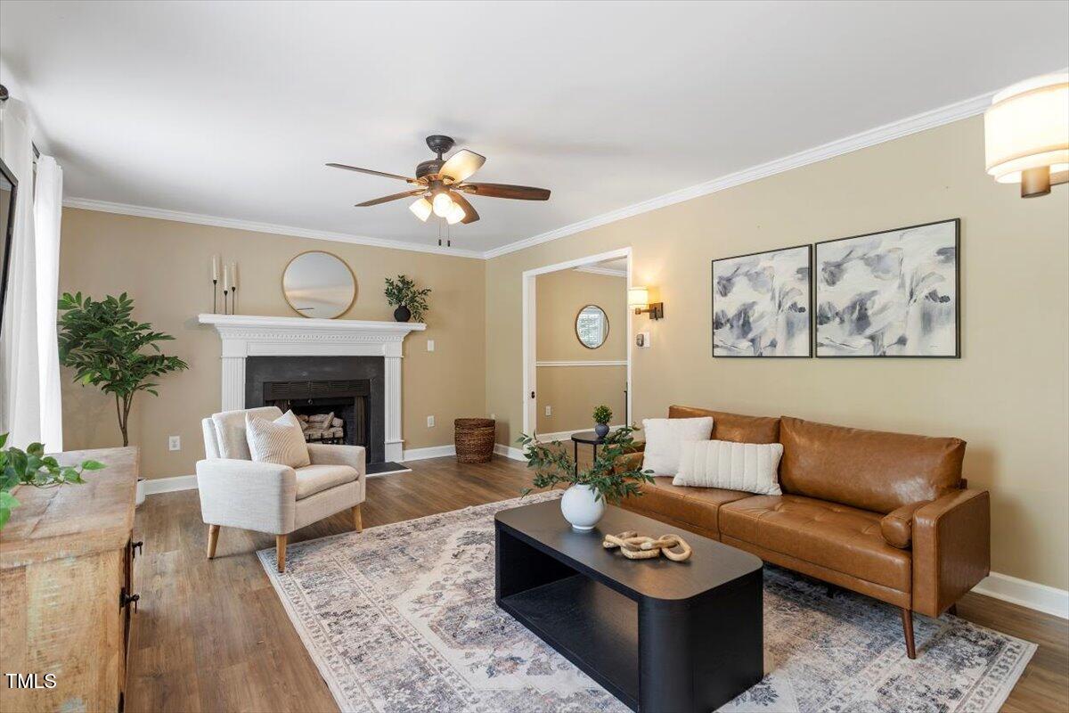 4725 Sinclair Drive Raleigh, NC 27616 - Photo 8 of 36 a living room with furniture a fireplace and a flat screen tv