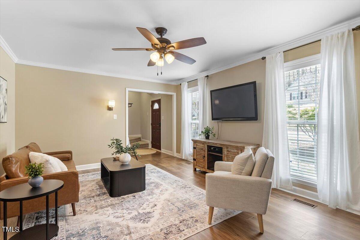 4725 Sinclair Drive Raleigh, NC 27616 - Photo 10 of 36 a living room with furniture a flat screen tv and kitchen view