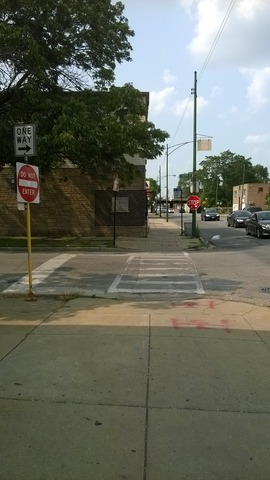 11700 South Michigan Avenue Chicago, IL 60628 - Photo 8 of 8 a street sign on a sidewalk next to a road