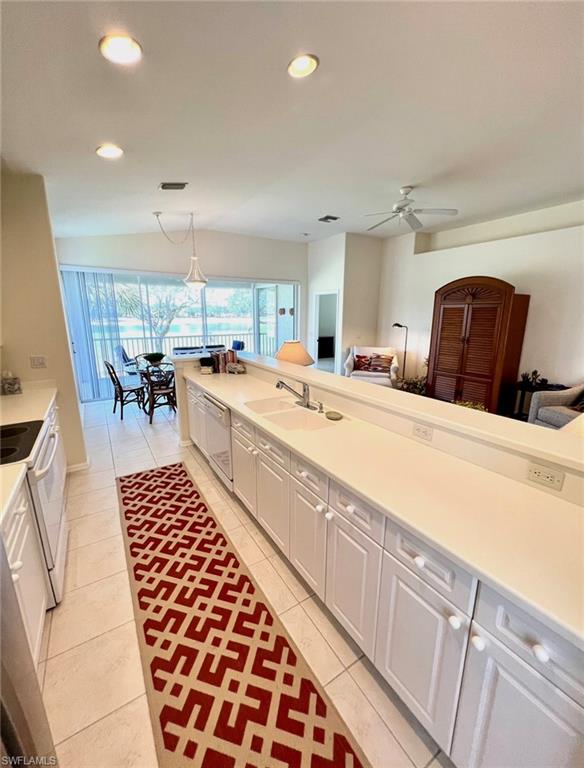 1957 Crestview Way, Unit 160 Naples, FL 34119 - Photo 11 of 32 a large white kitchen with a large window