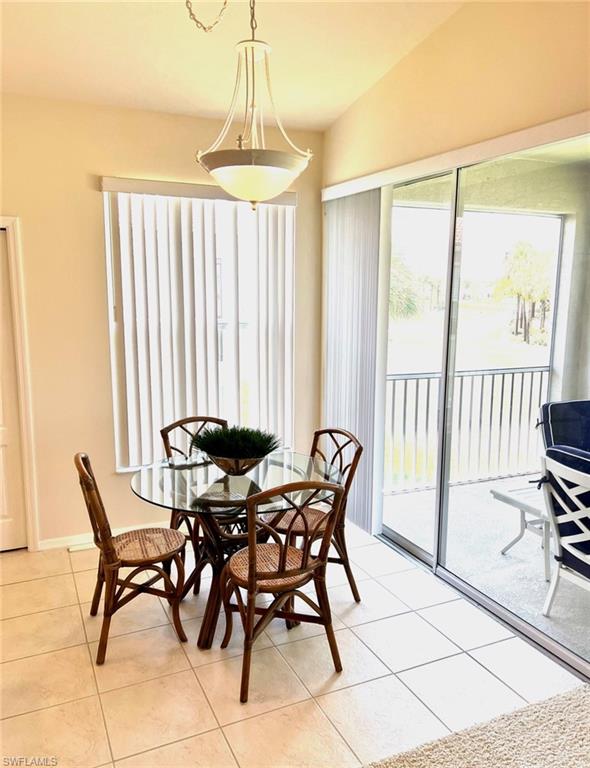 1957 Crestview Way, Unit 160 Naples, FL 34119 - Photo 13 of 32 a view of a dining room with furniture and a window