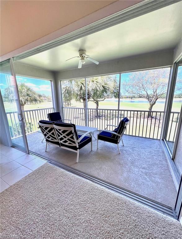 1957 Crestview Way, Unit 160 Naples, FL 34119 - Photo 15 of 32 a living room with furniture and a floor to ceiling window