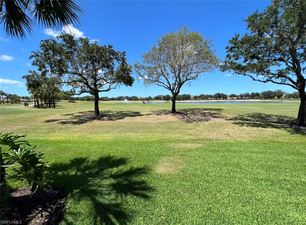 1957 Crestview Way, Unit 160 Naples, FL 34119 - Photo 16 of 32 a view of a yard with an trees