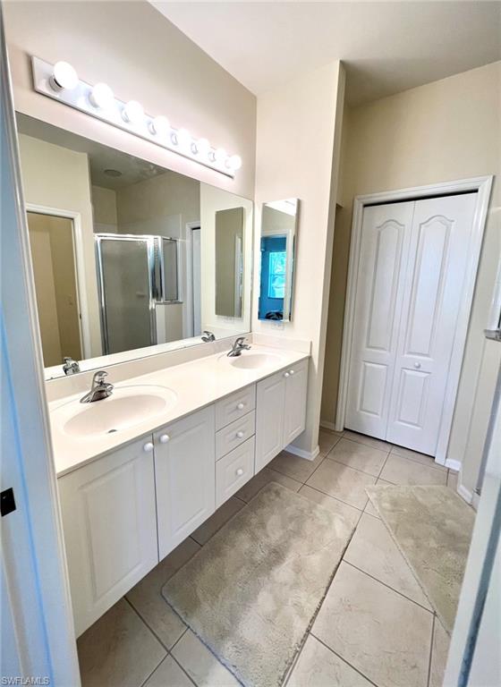 1957 Crestview Way, Unit 160 Naples, FL 34119 - Photo 19 of 32 a spacious bathroom with a double vanity sink and a mirror