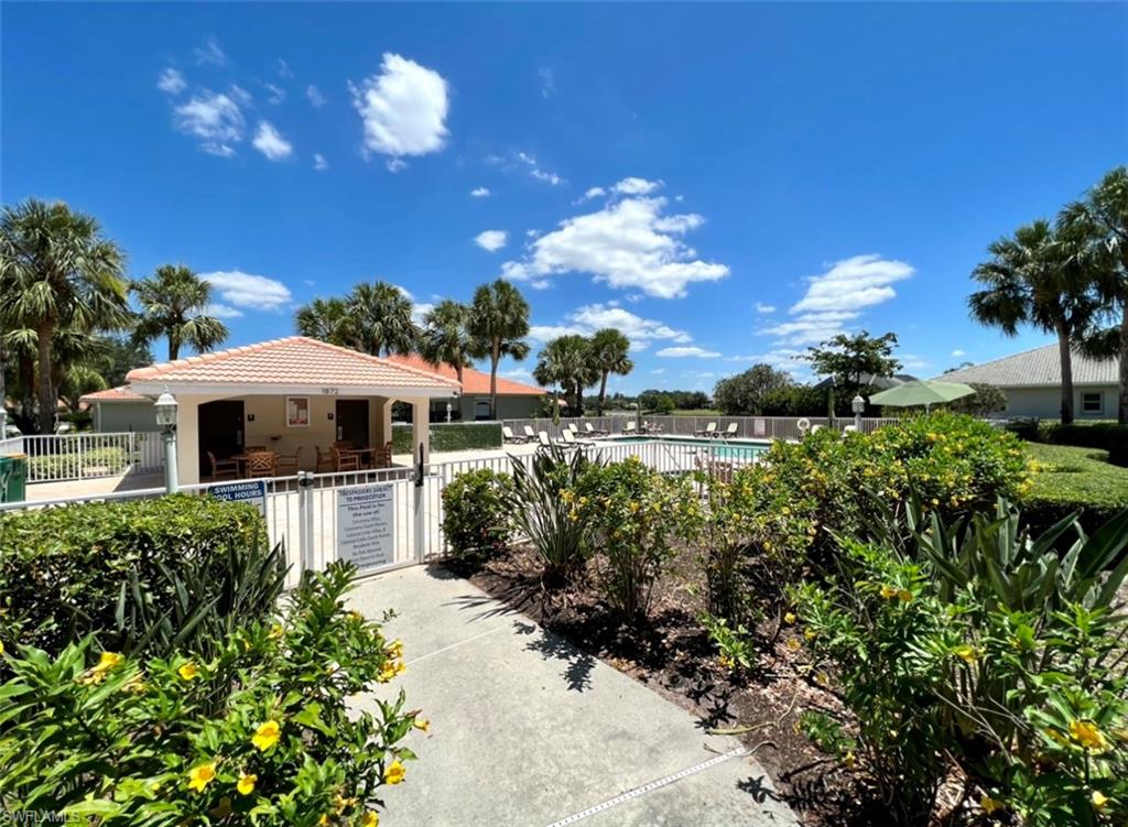 1957 Crestview Way, Unit 160 Naples, FL 34119 - Photo 28 of 32 a view of a house with a yard and garden