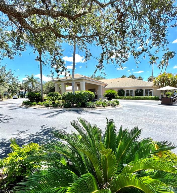 1957 Crestview Way, Unit 160 Naples, FL 34119 - Photo 29 of 32 a swimming pool with outdoor seating area and trees