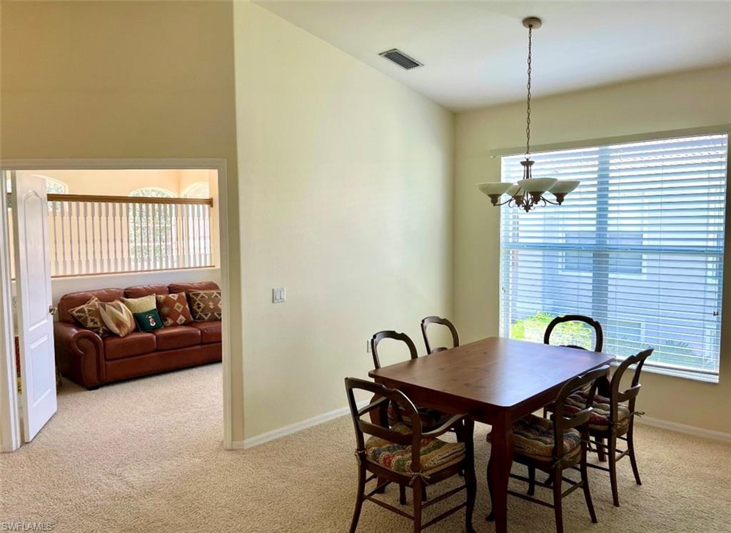 1957 Crestview Way, Unit 160 Naples, FL 34119 - Photo 6 of 32 a view of a dining room with furniture and window