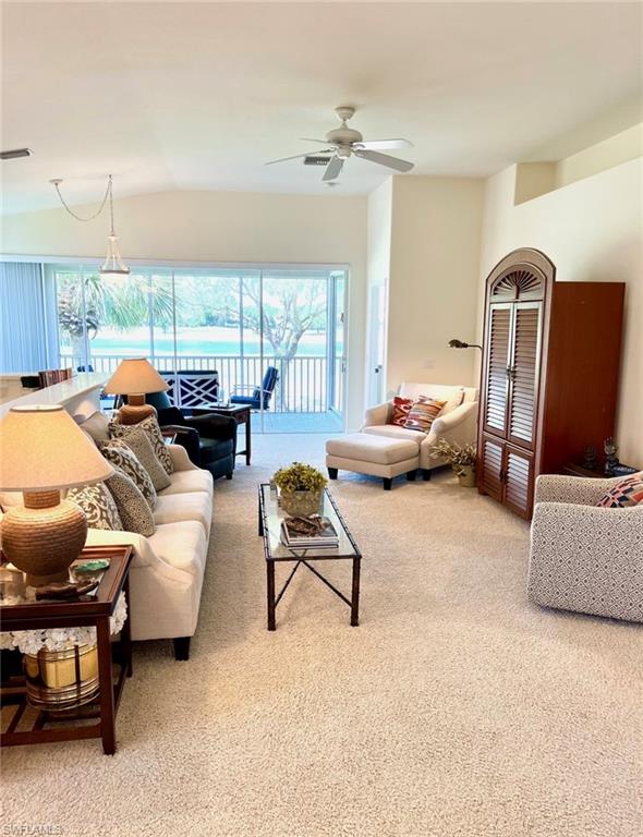 1957 Crestview Way, Unit 160 Naples, FL 34119 - Photo 9 of 32 a living room with furniture gym equipment and large windows