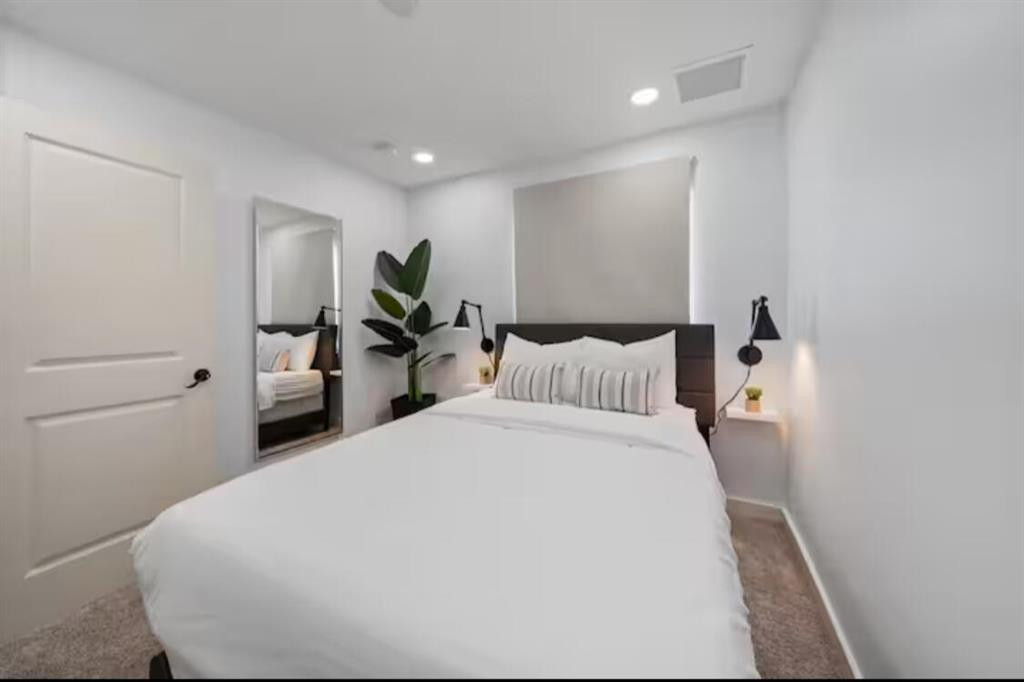 1559 West 26th Court Riviera Beach, FL 33404 - Photo 13 of 17 a bed room with a bed and a potted plant