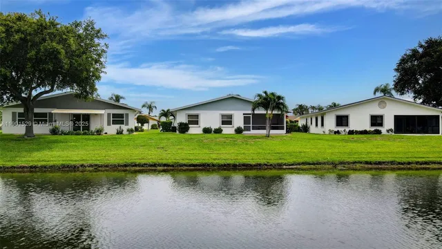 an aerial view of residential houses with outdoor space and swimming pool