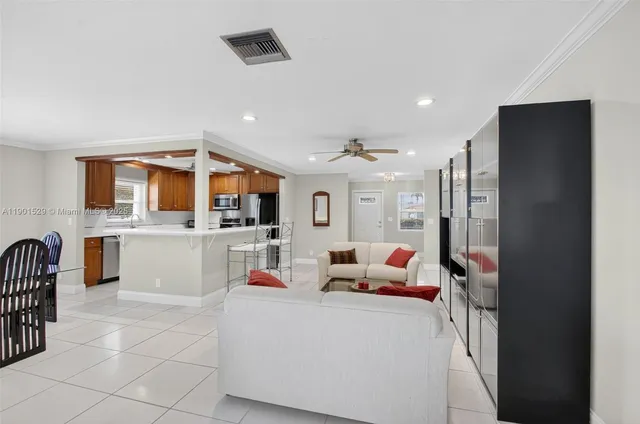 a kitchen with a sink refrigerator and cabinets