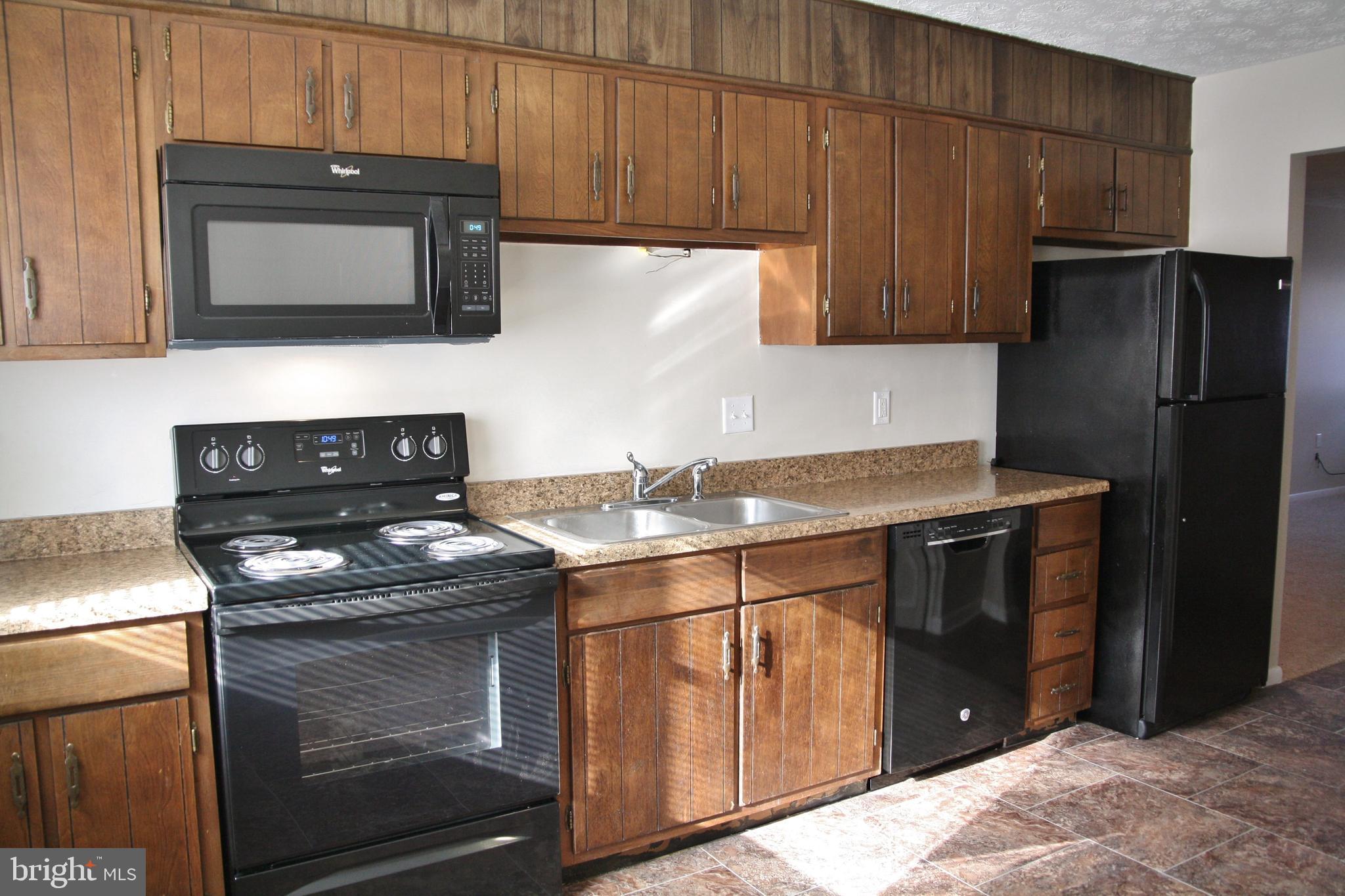 6007 Willow Spring Road, Unit D Harrisburg, PA 17111 - Photo 1 of 12 a kitchen with stainless steel appliances granite countertop a stove microwave and refrigerator