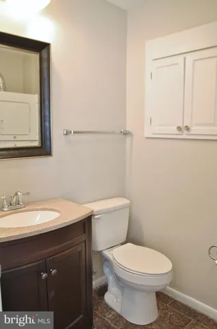 a bathroom with a sink a toilet and mirror