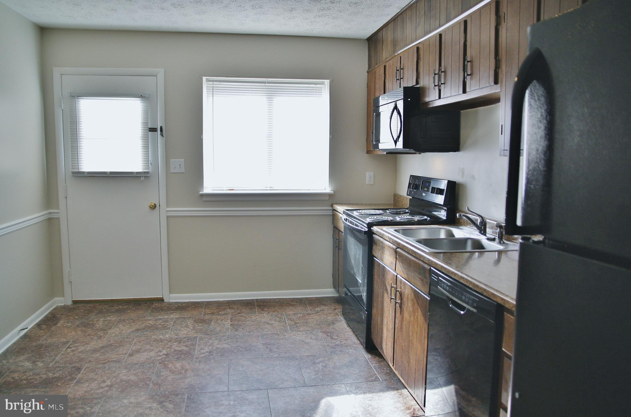 6007 Willow Spring Road, Unit D Harrisburg, PA 17111 - Photo 2 of 12 a kitchen with stainless steel appliances granite countertop a stove a sink and a refrigerator
