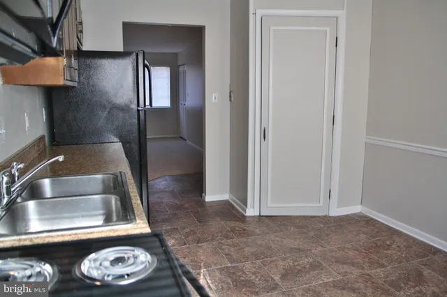 a kitchen with a sink and a refrigerator