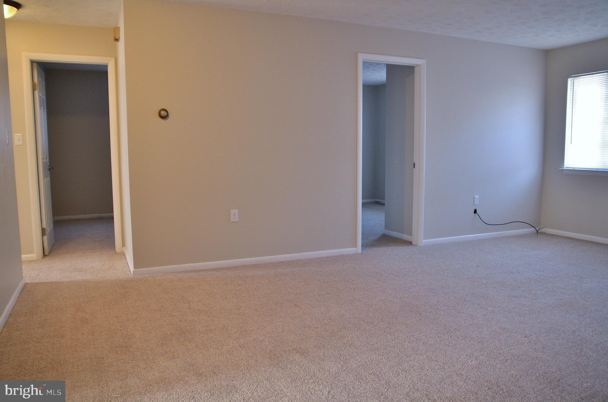 6007 Willow Spring Road, Unit D Harrisburg, PA 17111 - Photo 4 of 12 a view of an empty room with windows and closet