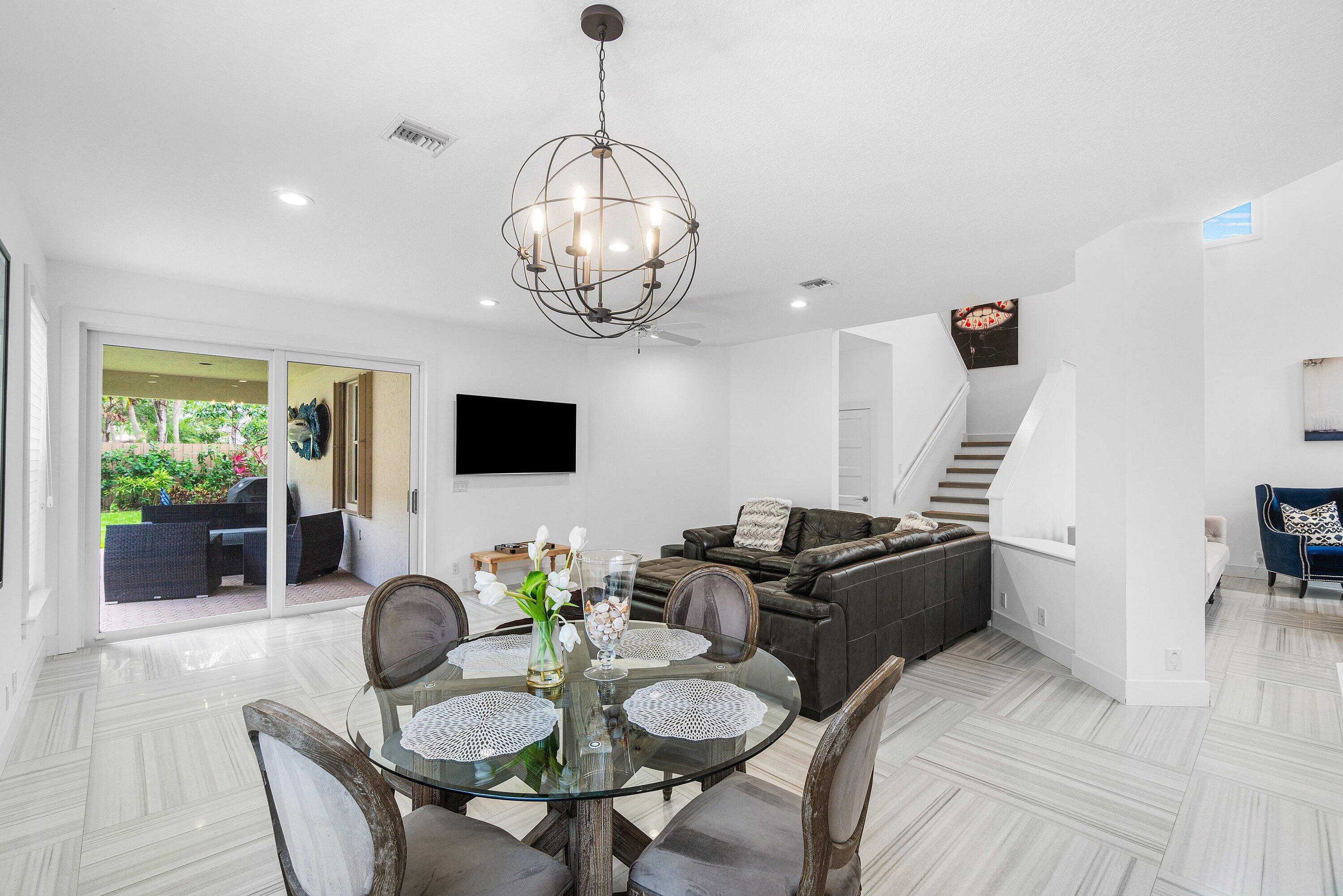 2404 Northwest 67th Street Boca Raton, FL 33496 - Photo 12 of 74 a living room with couches chairs and couches with wooden floor