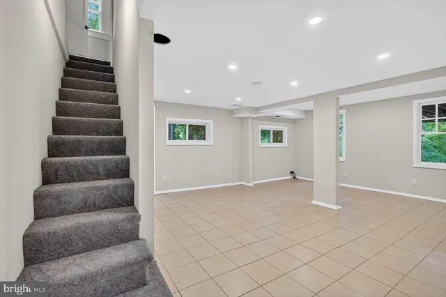 an empty room with windows and closet