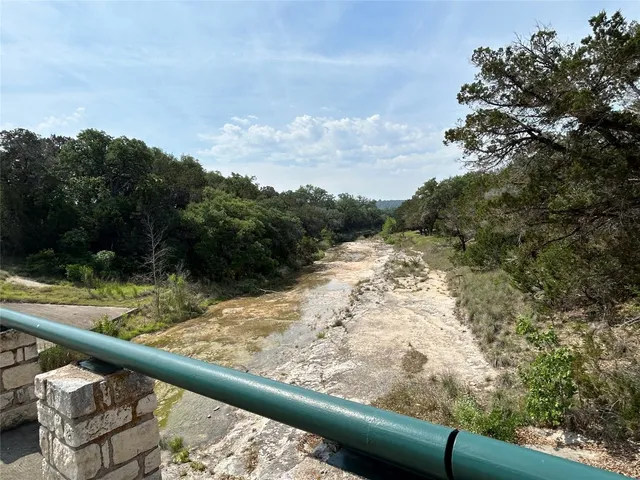 a view of a yard with wooden fence