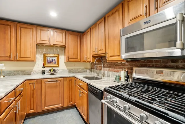 a kitchen with a sink stove top oven and cabinets