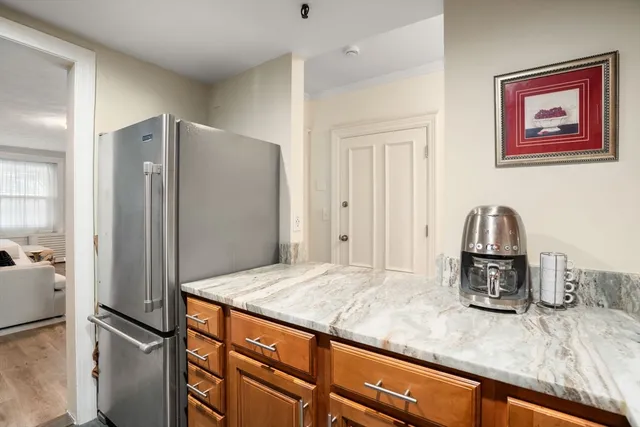 a kitchen with kitchen island a refrigerator and stove