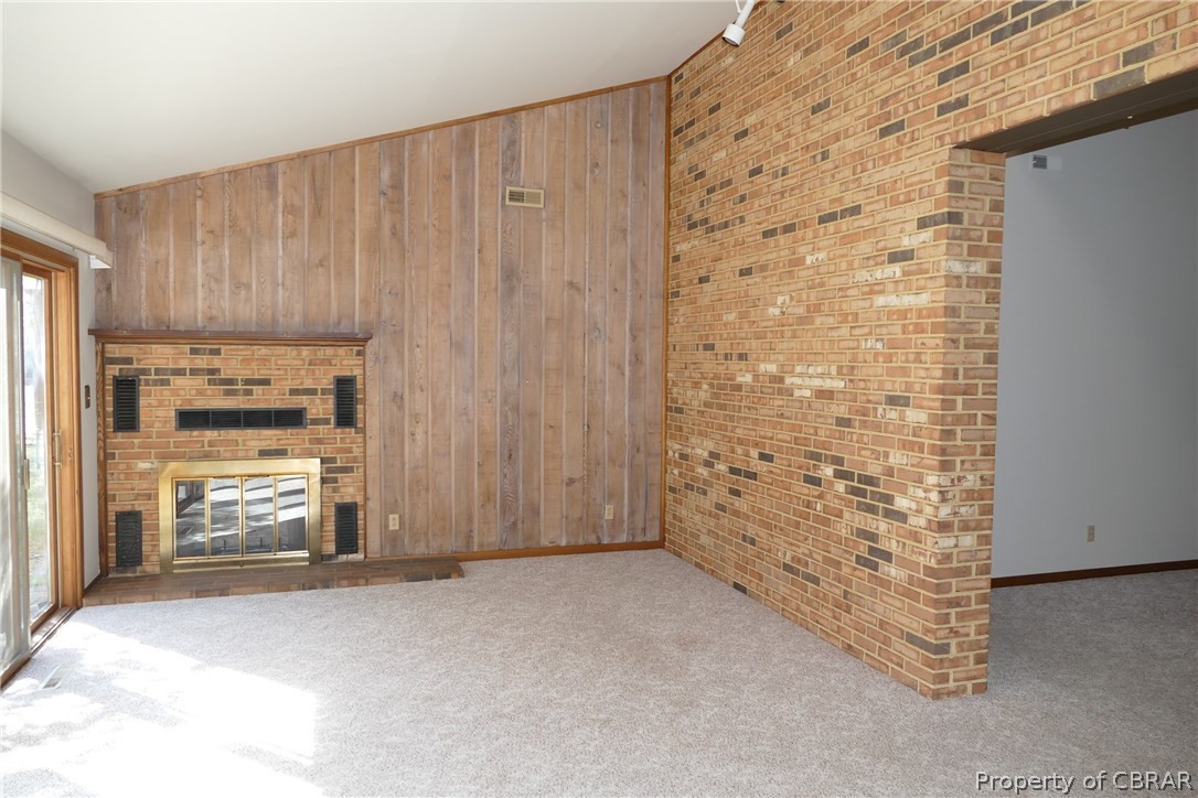 895 Holly Point Road Mathews, VA 23109 - Photo 22 of 47 a view of an empty room with a fireplace