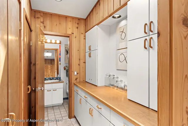 a bathroom with a granite countertop sink mirror and a shower