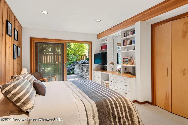 a bedroom with a large bed and a window