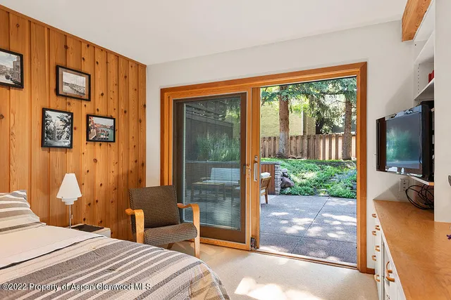 a bedroom with a large window and a bed