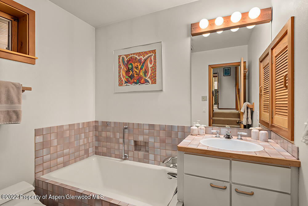 311 West North Street, Unit A Aspen, CO 81611 - Photo 19 of 39 a bathroom with a tub a sink and mirror