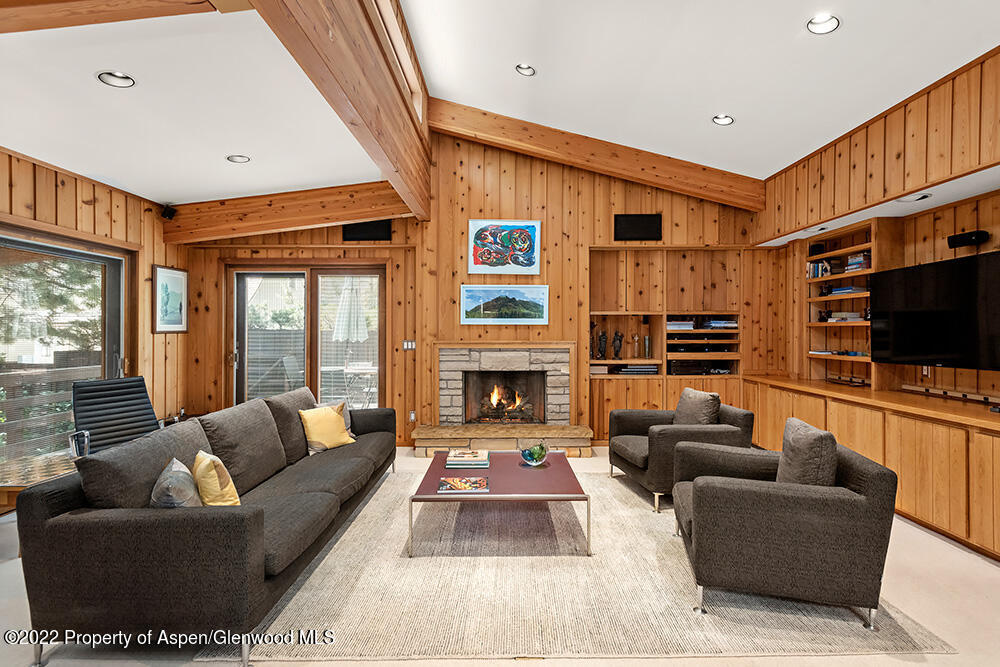 311 West North Street, Unit A Aspen, CO 81611 - Photo 2 of 39 a living room with furniture a flat screen tv and a fireplace