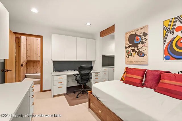 a bedroom with a workspace