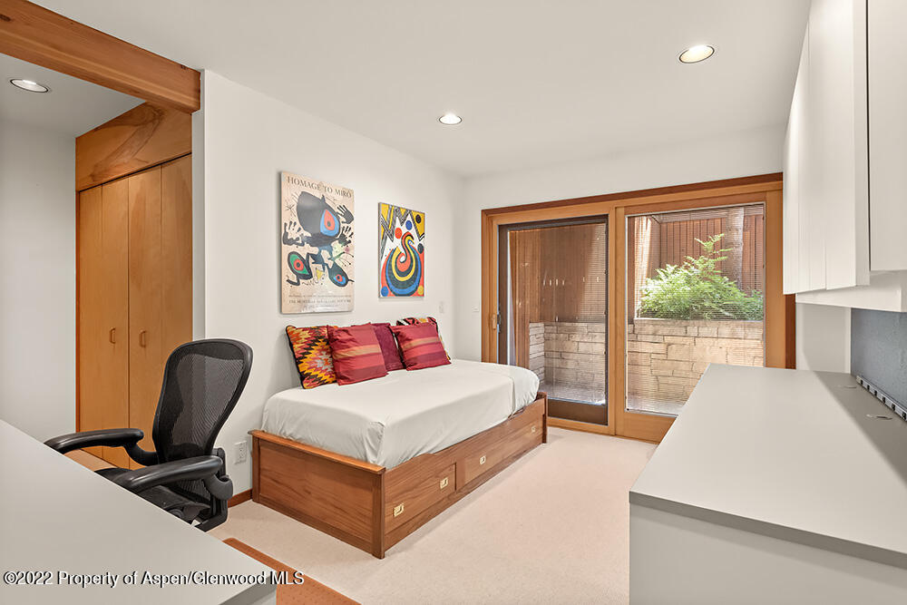 311 West North Street, Unit A Aspen, CO 81611 - Photo 22 of 39 a bedroom with a bed and a large window