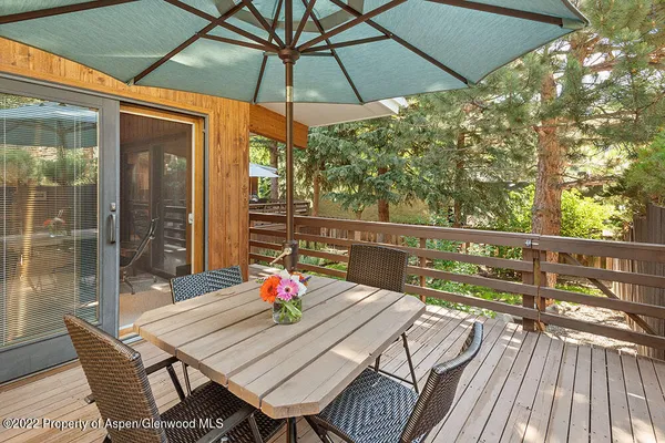 a view of balcony with furniture and umbrella