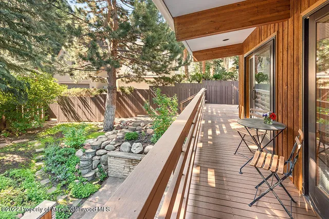a view of balcony with wooden floor and outdoor seating