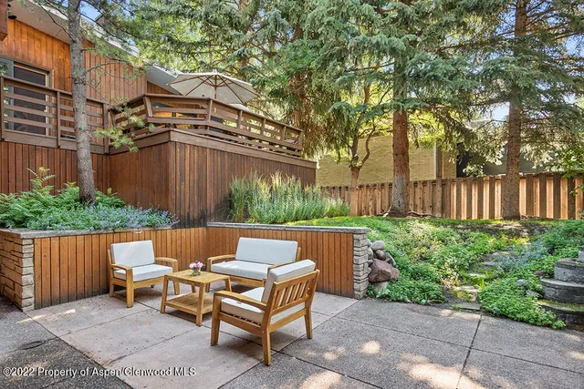 a view of a bench in back yard of a house