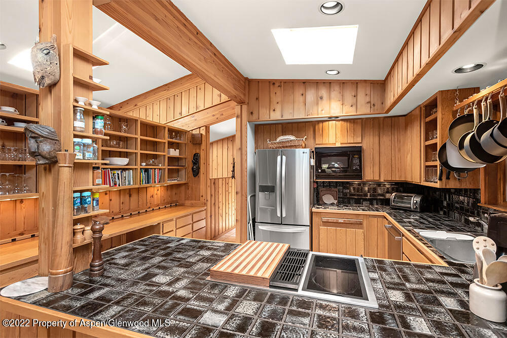 311 West North Street, Unit A Aspen, CO 81611 - Photo 10 of 39 a kitchen with granite countertop a stove a sink and a microwave