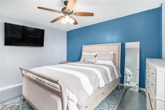 a bedroom with a bed and a flat screen tv