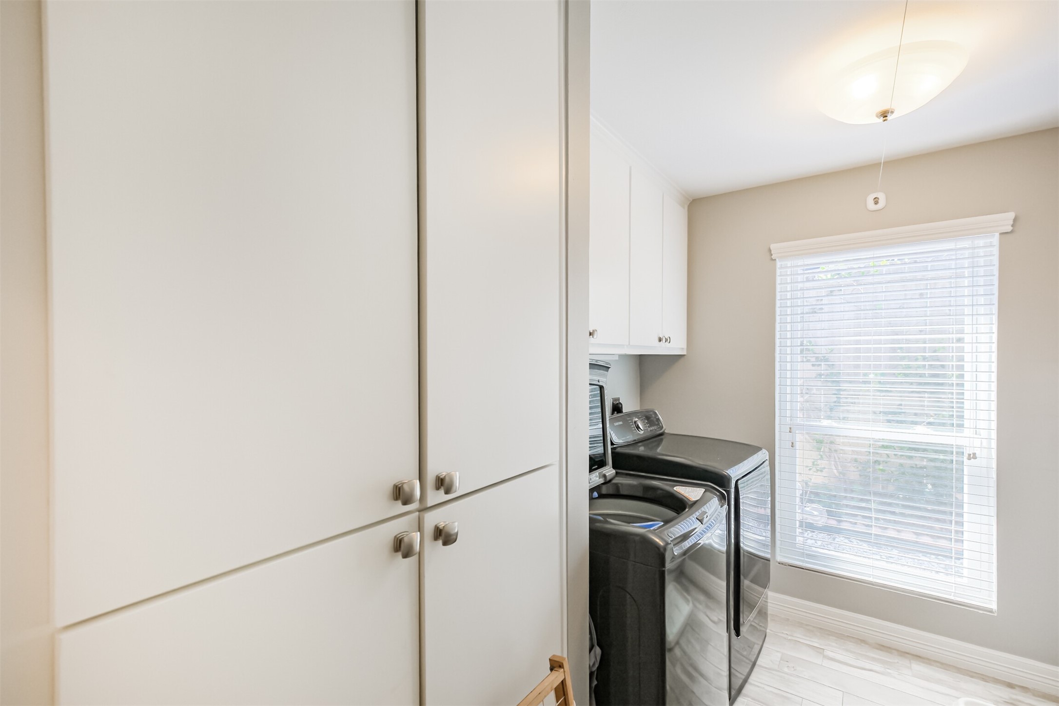 1007 Arrow Hill Road Houston, TX 77077 - Photo 35 of 48 The utility room accommodates a full size washer and dryer. There is also extra cabinet space for storage.