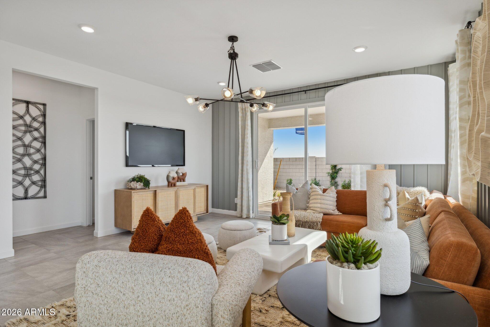 26449 West Crown King Road Buckeye, AZ 85326 - Photo 13 of 33 a living room with furniture and a flat screen tv