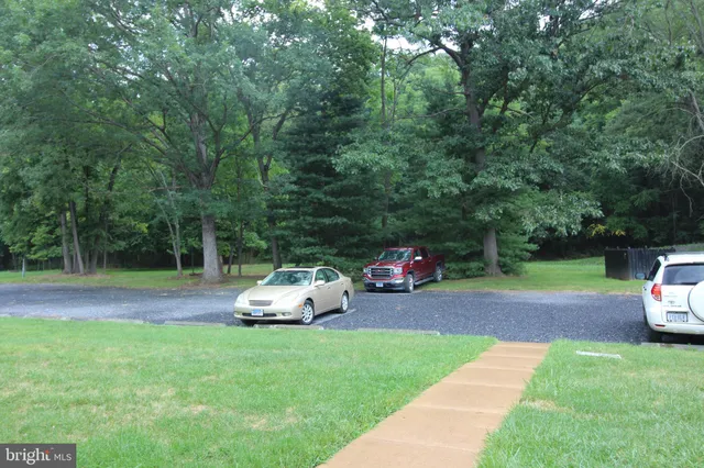 a view of a backyard with lawn chairs and a slide