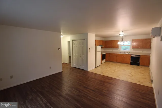 a view of a kitchen with a sink and a refrigerator
