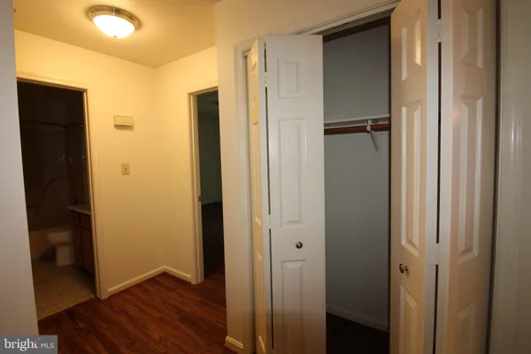 a view of closet area with wooden floor