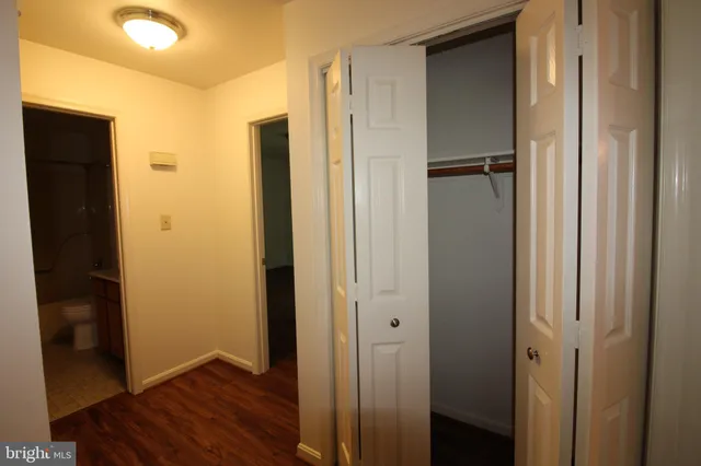 a view of closet area with wooden floor